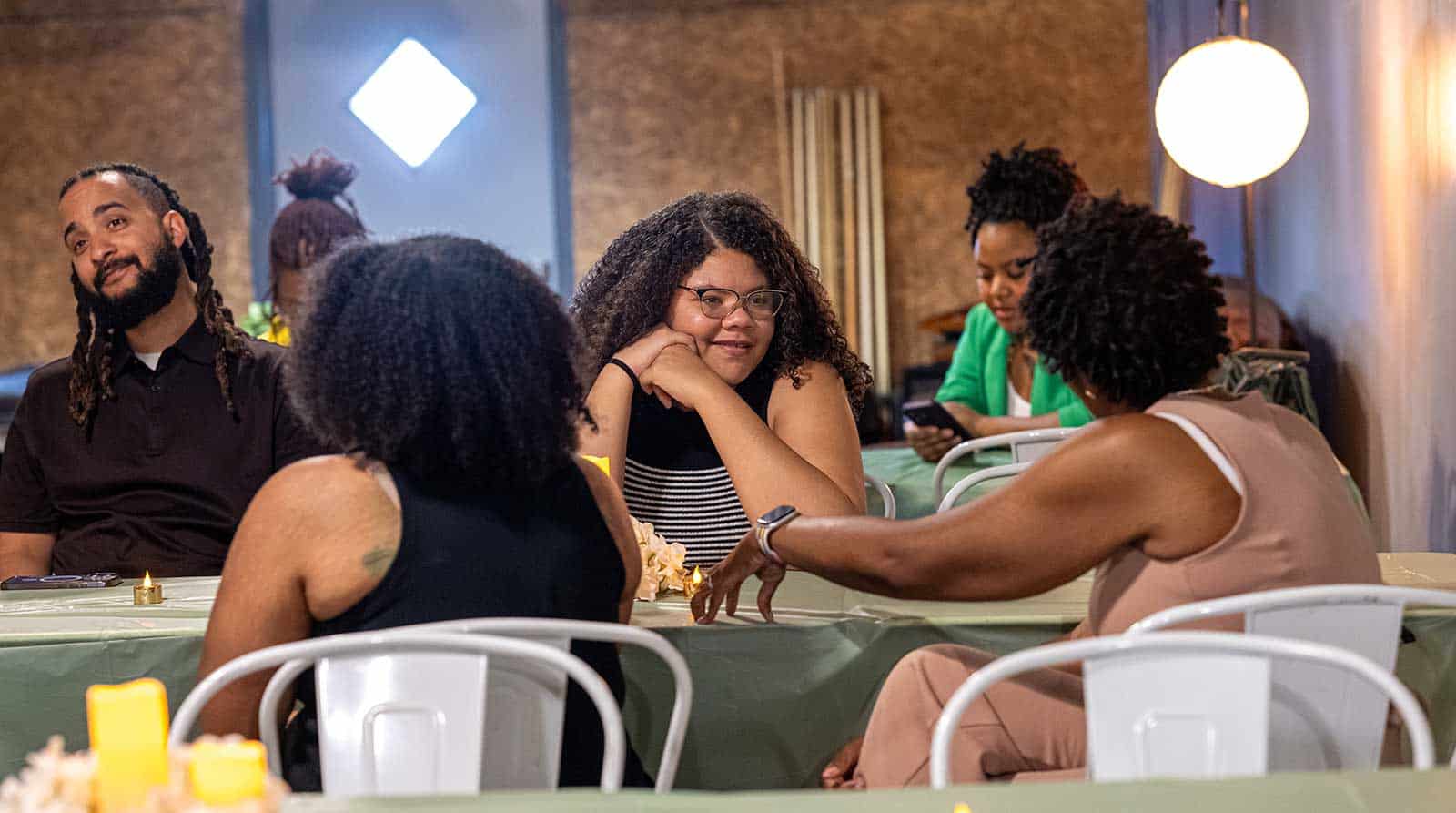 People in conversation at a table.